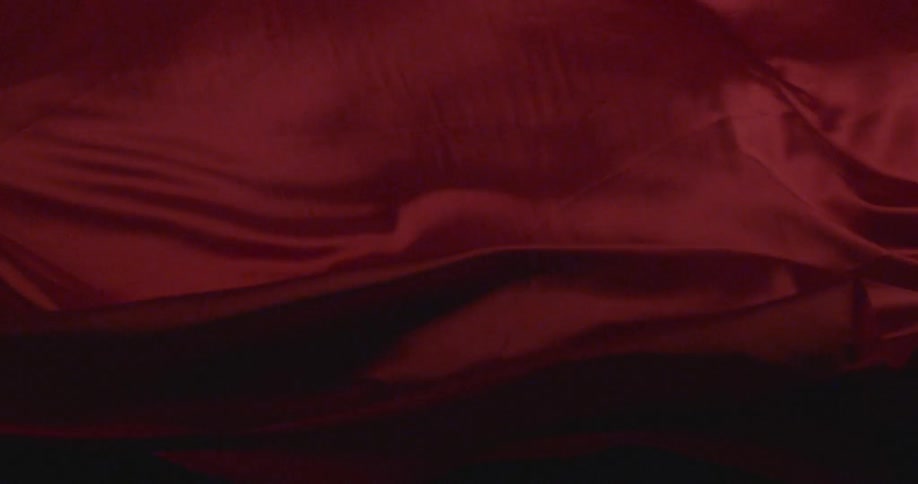 A red fabric is waving and fluttering