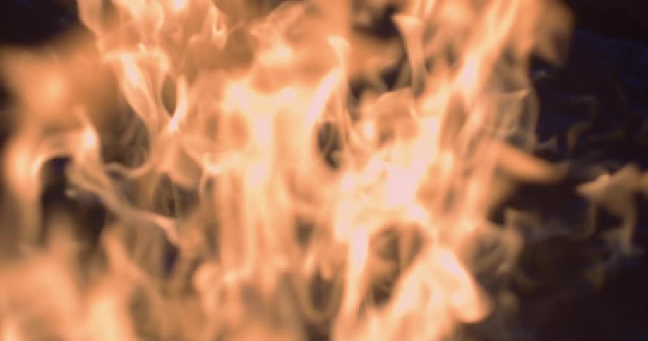 Flames roll and burn against a black backdrop