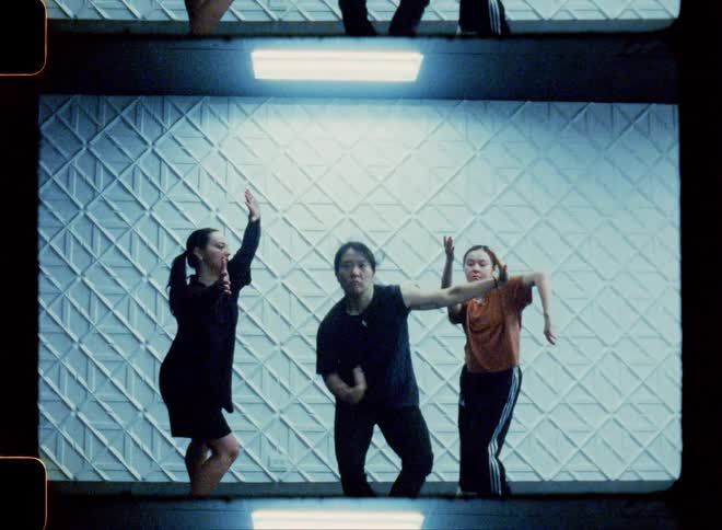 Dancers at a performance in a white room
