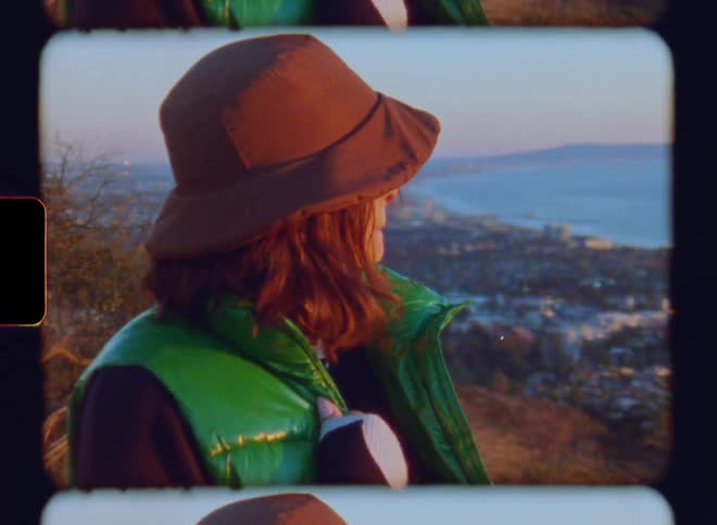 Face of a lady smiling while standing near the coast during the day