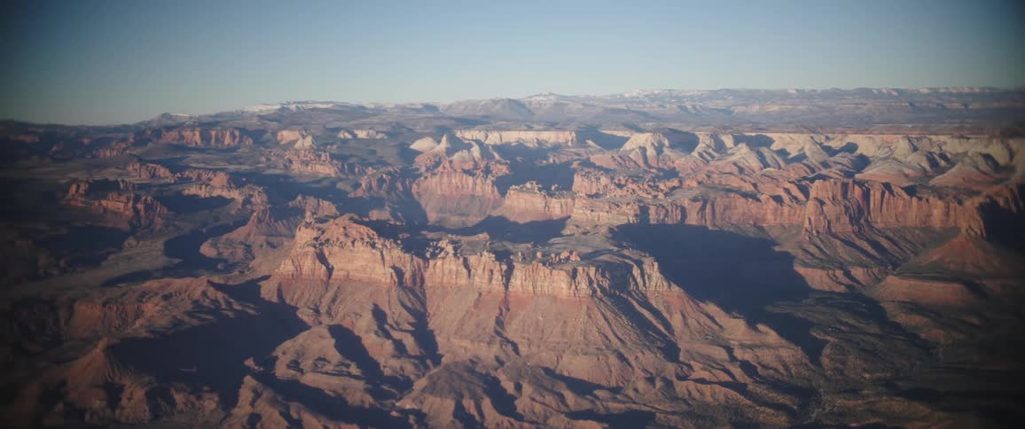 Large canyons near a huge mountain range