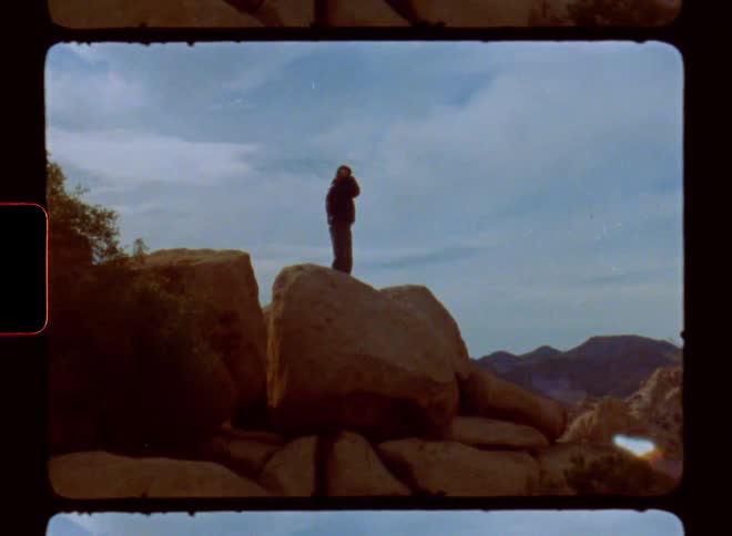 Man on top of a rock in a canyon