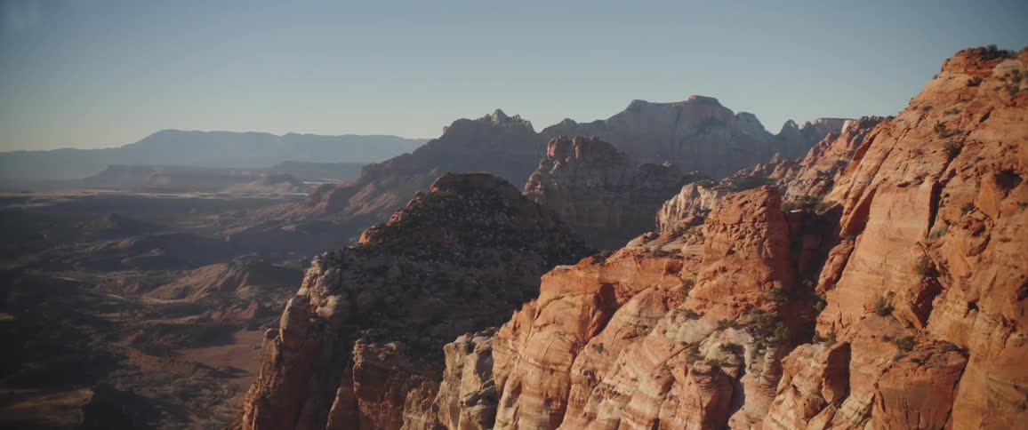 Aerial panorama of rocky geological formations in the morning sky