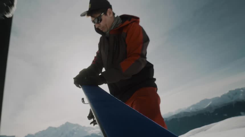A skier preparing equipment for a skitour