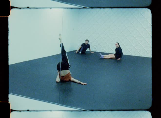 A teenager dances as two other girls look on