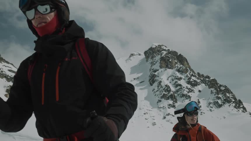 Riders climb a snowy mountain during the freezing winter
