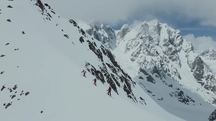 Skiers climb a snowcovered mountain during a harsh winter