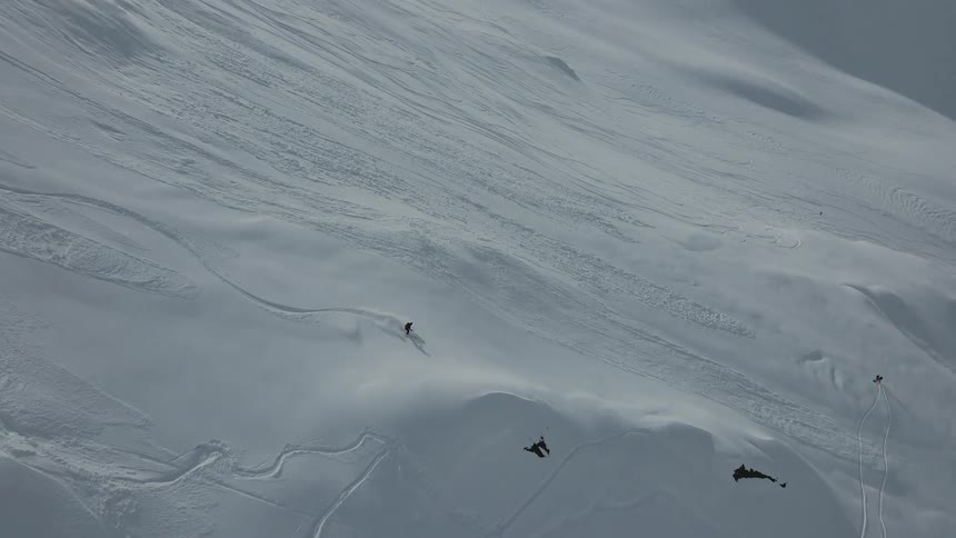Person skiing down a huge slope of a snowcovered mountain