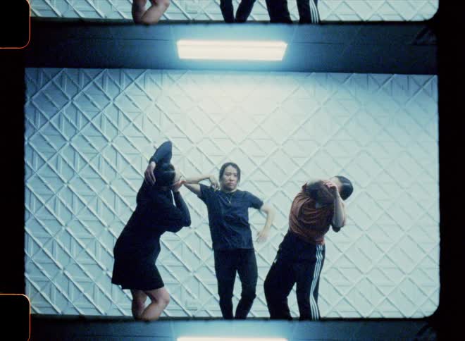 Three women in a studio dancing a joint choreography