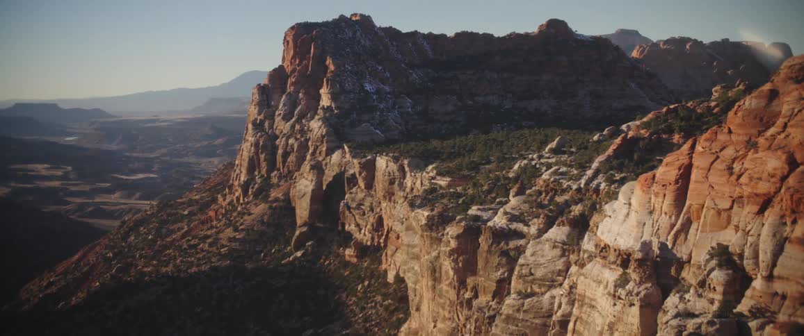 Aerial panorama of rocky mountain ranges in the morning sky