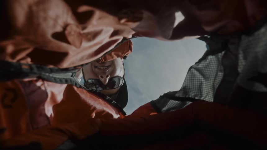 Camera inside a backpack and a man opening it