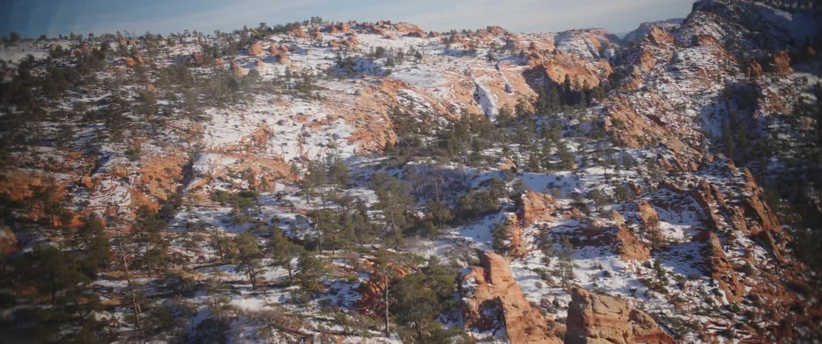 Aerial panorama of rocky mountain peaks covered by snow