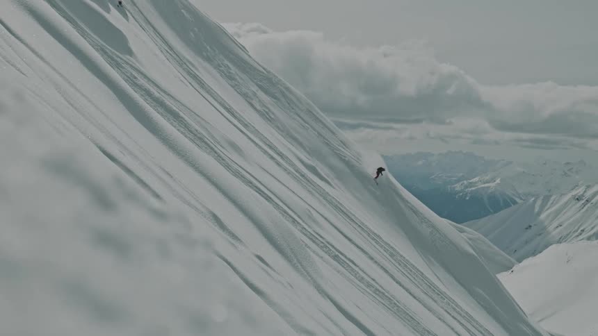 A skier freeriding on a mountain covered in snow