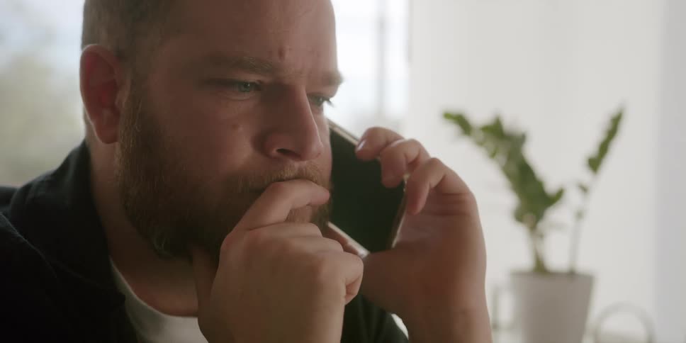 Portrait of a man answering a phone call and talking
