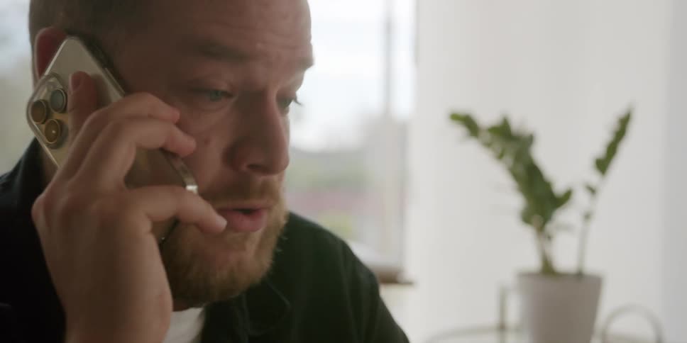 Portrait of a somewhat upset man talking on the phone