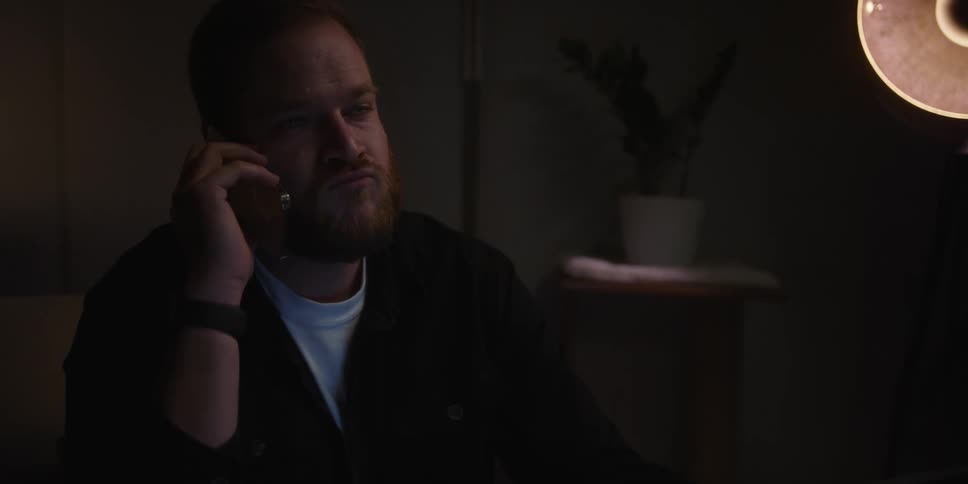A man sitting in a room at night looking sad