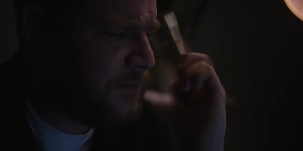 A man speaks to someone on a phone