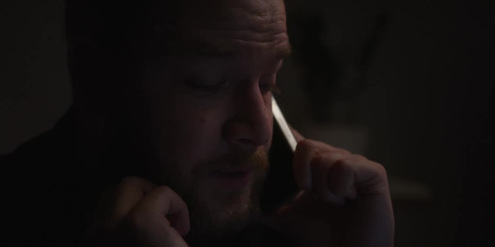 A man speaks rather animatedly into a smart phone