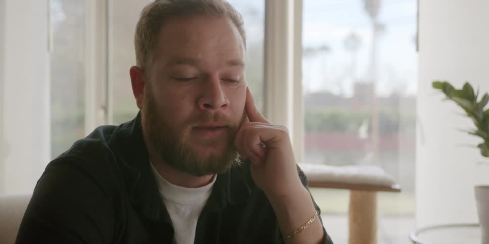 A man is worried as he talks on his cell phone