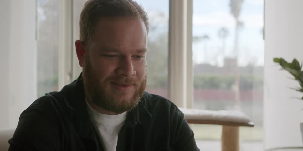 Portrait of a thoughtful and happy man at the same time in a room