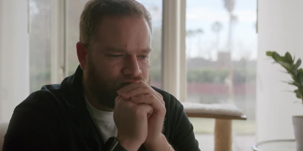 Portrait of a man drinking a glass of water and with a worried facial expression