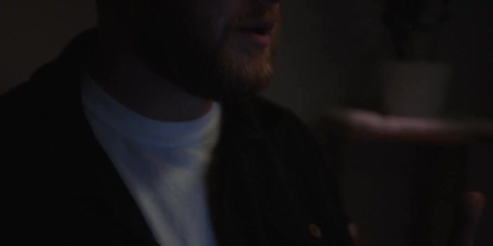 A man speaks and uses his hands to gesture