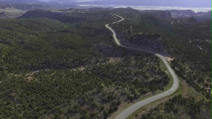 Aerial view of bicyclists on a road in the wilderness
