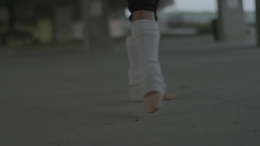 A person dances on the concrete