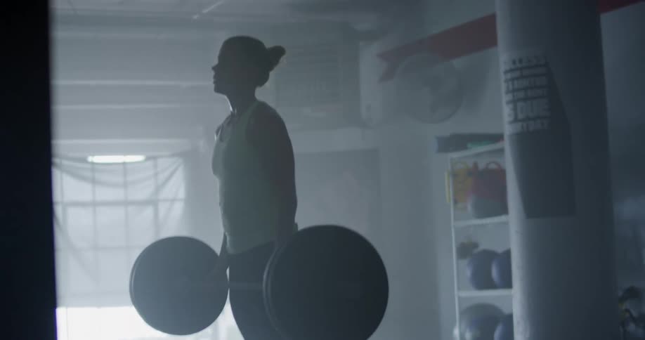 An athletic woman lifting weights