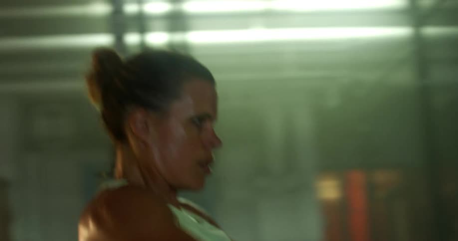 Portrait of a concentrated woman performing pulling movements in the gym