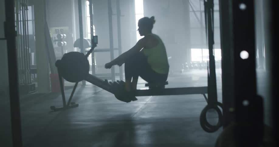 A woman is working out on the exercise equipment