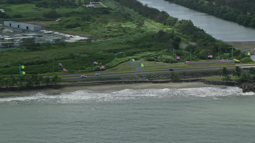 A long road parallel to the sea and crossing a river