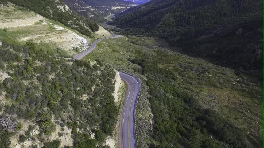 A bicycle is moving along a windy mountain road
