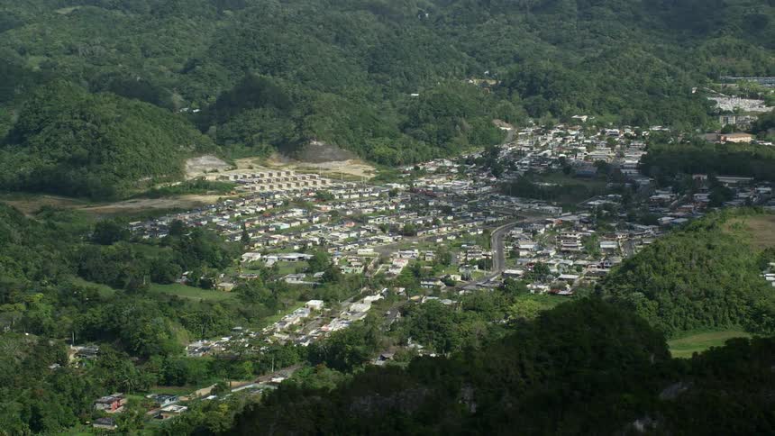 A group of homes is between the mountains