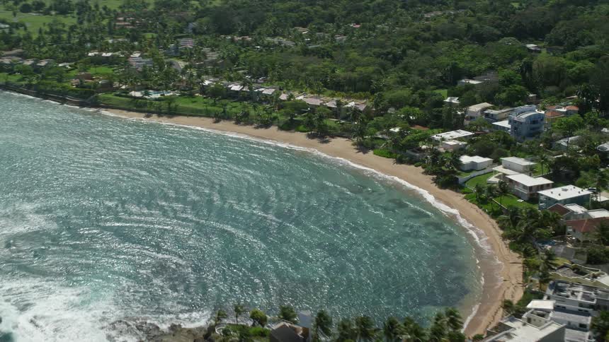 A small residential area on a beach facing the sea