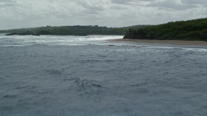 Waves crash against the island shore