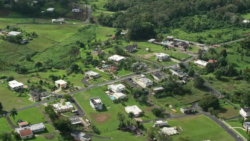 Homes in a rural area surrounded by fields and forests