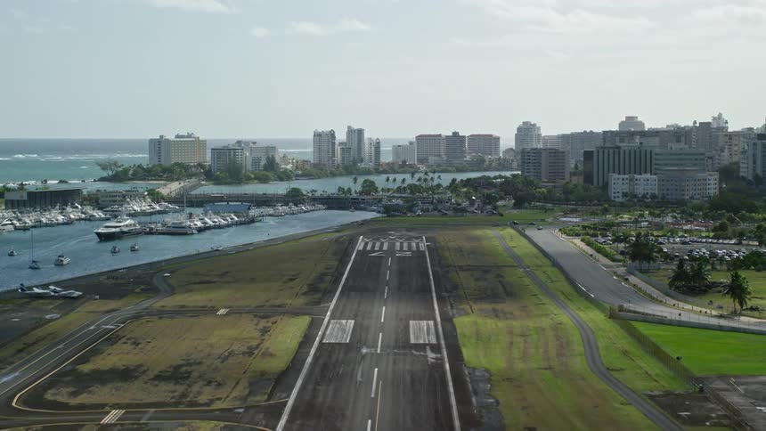 An airport sits near a coastal city