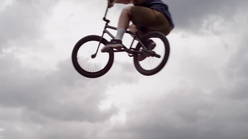 A bmx rider jumps through the air
