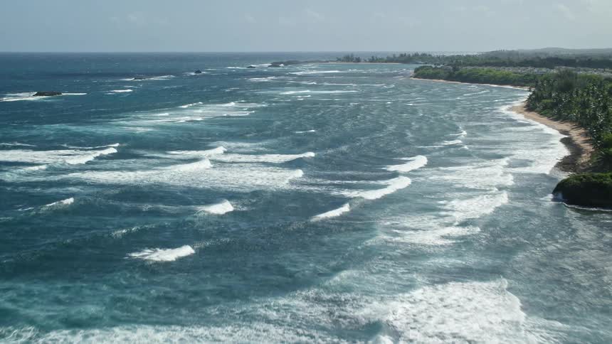 Rough waters crash against the island