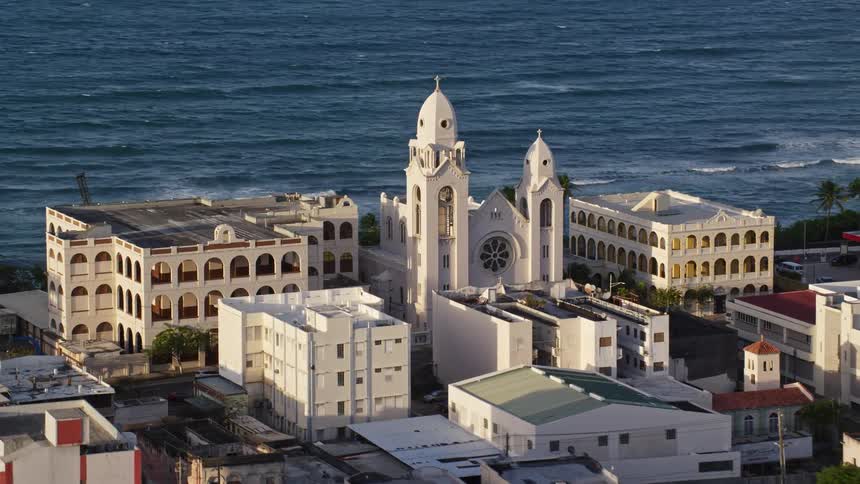 A town is on the shore of the tropical island