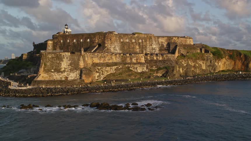 Aerial panorama of a fortress under rocks on an island by the seaside