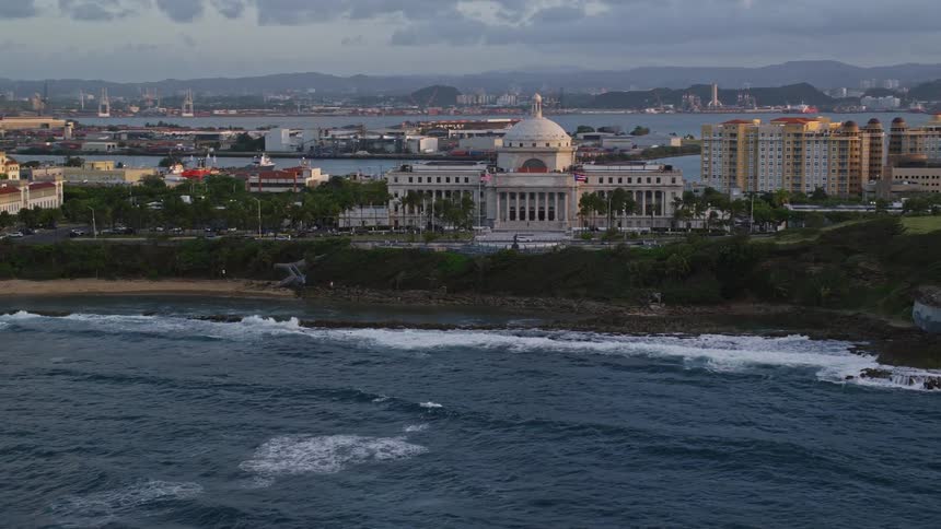 A building with a dome sits near the coast
