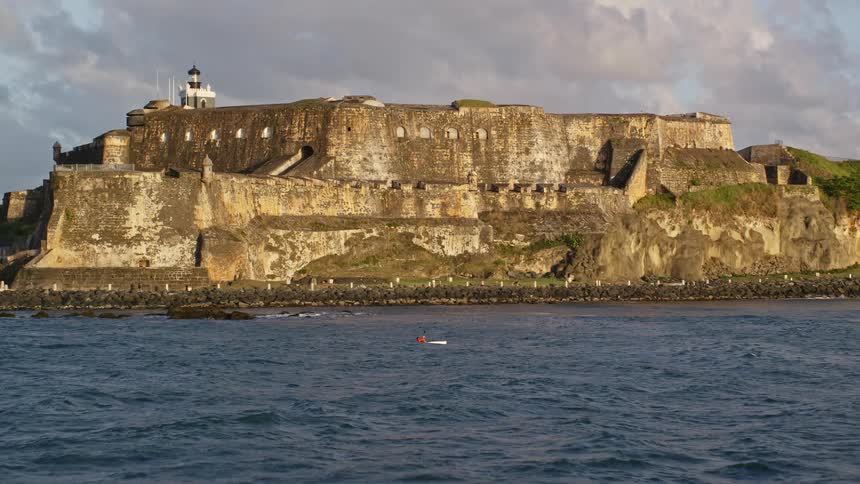 Aerial view of an old fortress and a modern city by the sea