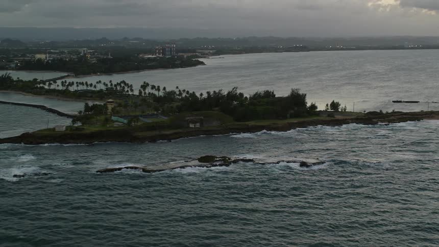 Aerial of an island full of trees at sunset
