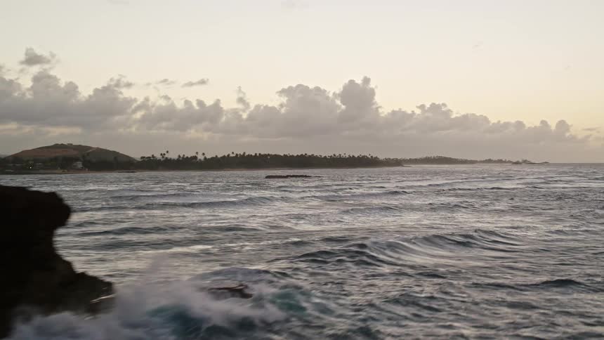 Aerial view of a rocky coast and tropical islets at sunset