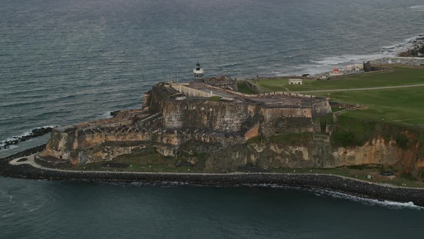 A fort with ancient architecture on the coast of an island and there is an immensity of sea on the horizon