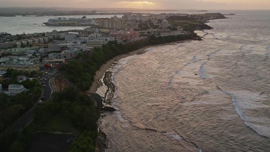 A sunset view of a city by the sea