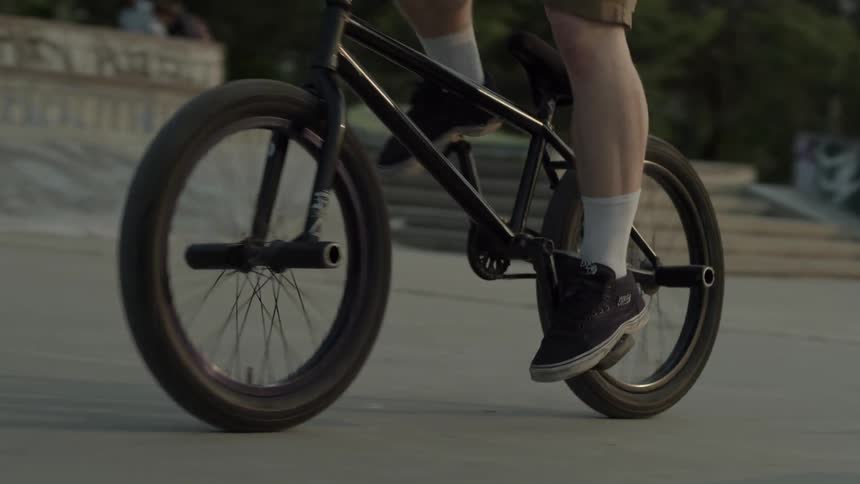 A person is riding their bike along the concrete