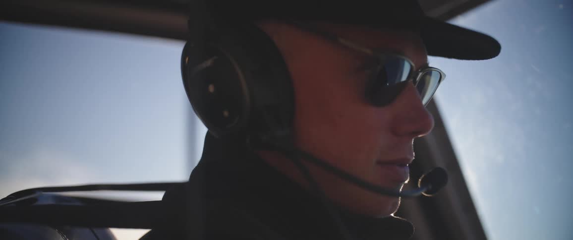 A man wearing sunglasses and a headset